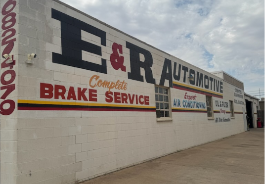E&R Automotive storefront with large sign and red brake service text on a cloudy day | E&R Automotive