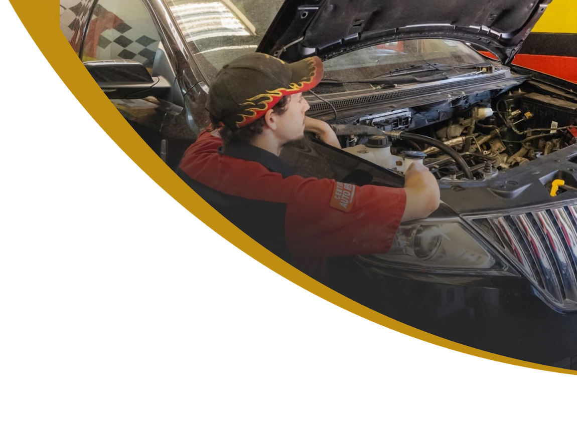 Person inspecting a car engine under an open hood, framed by a gold curved border | E&R Automotive
