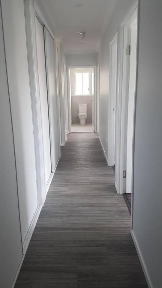 A Long Hallway Leading to A Bathroom and A Toilet — Allman's Painting in Monkland, QLD