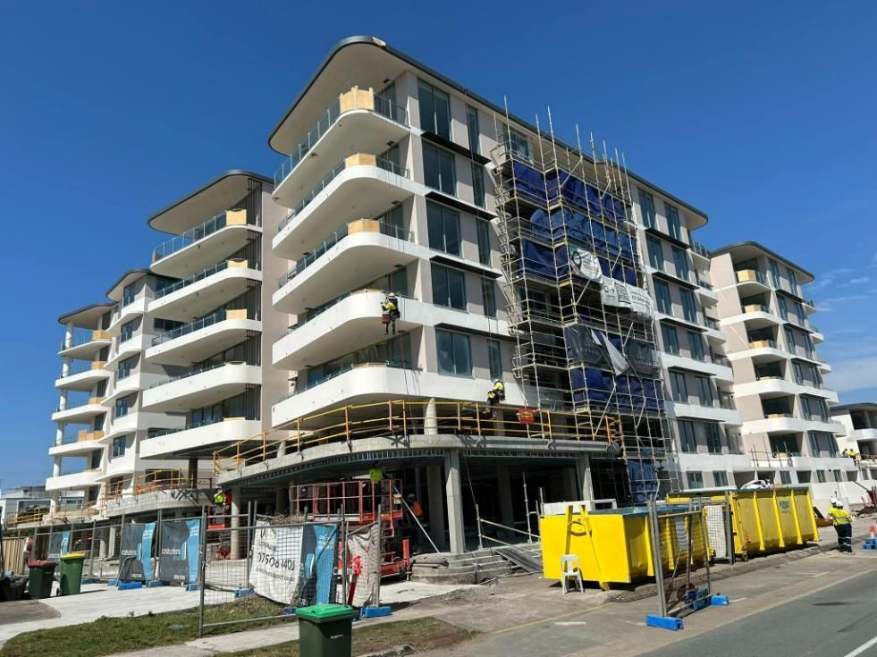 A Large Building Under Construction with Scaffolding on The Side of It — Allman's Painting in Monkland, QLD