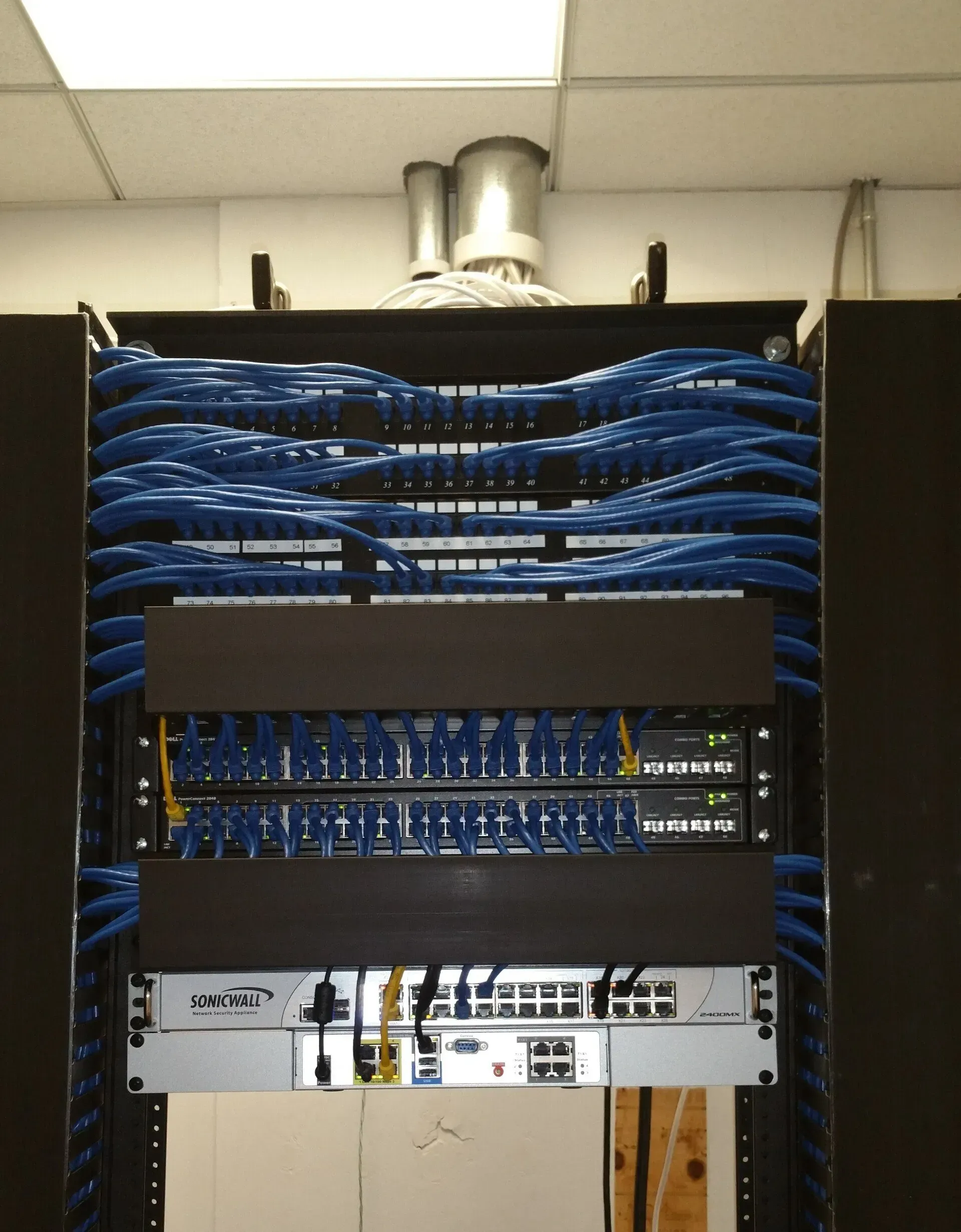A server rack with a lot of blue wires on it