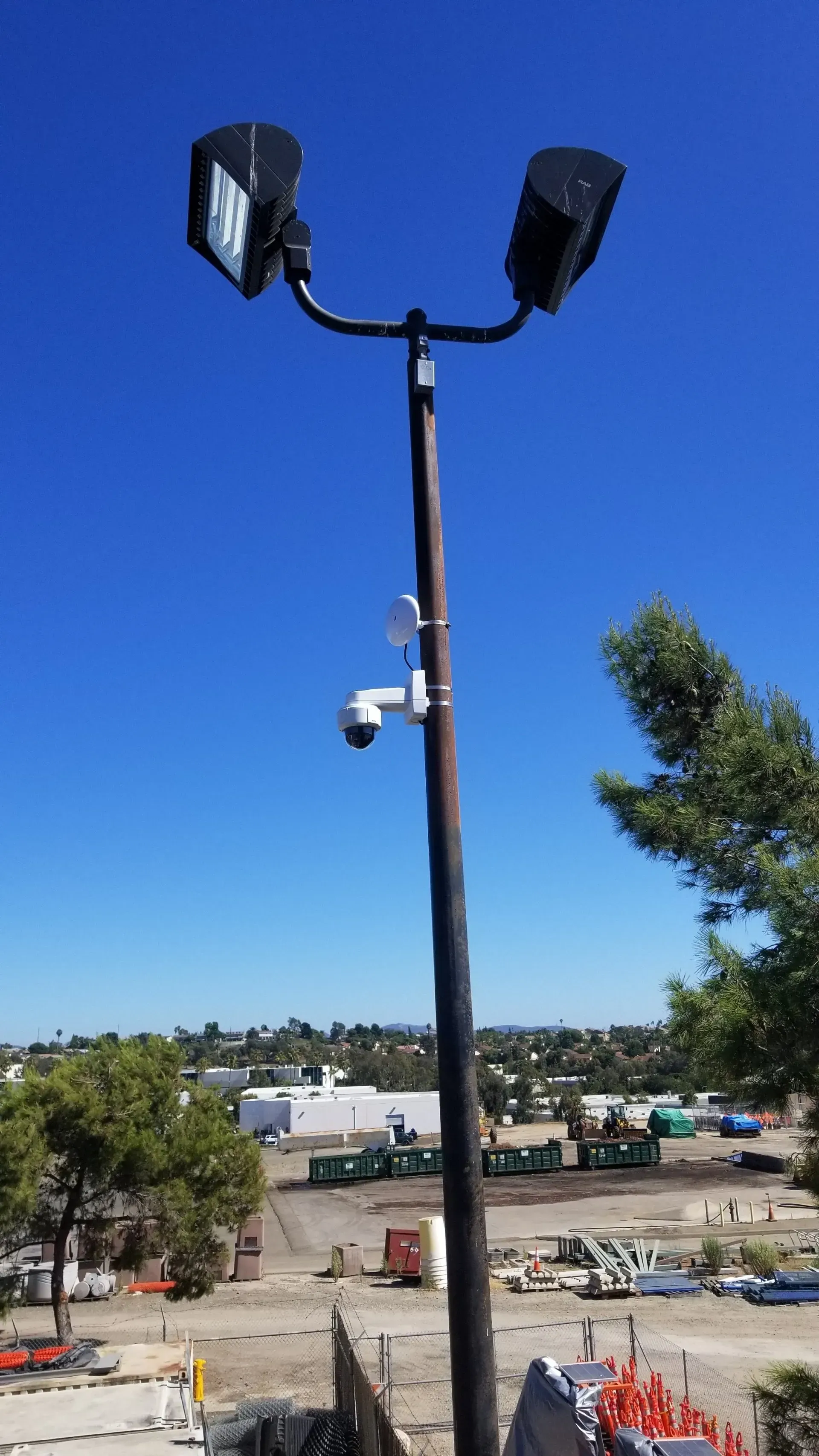 A very tall pole with two lights attached to it.