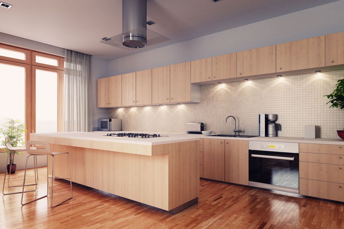 A kitchen with wooden cabinets and a large island in the middle.