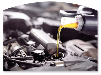 Motor oil pouring into a car engine through the oil filler opening