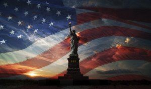 statue of liberty with the american flag in the background