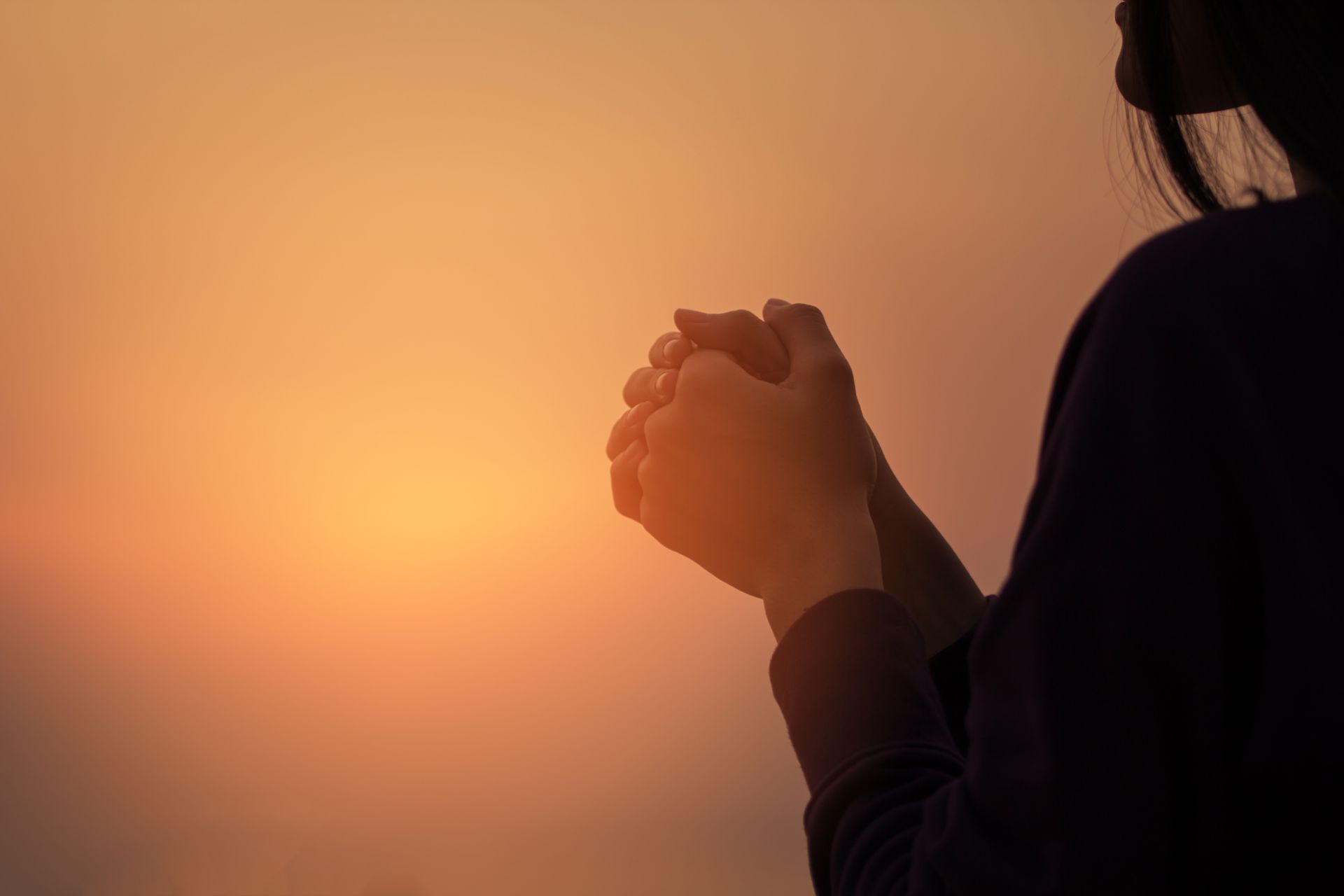 woman clasping hands