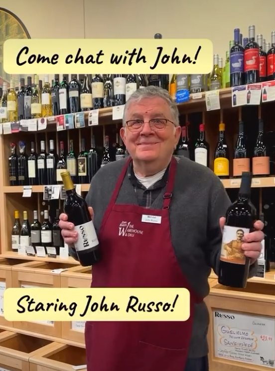 John holding wine bottles in a wine shop; text says