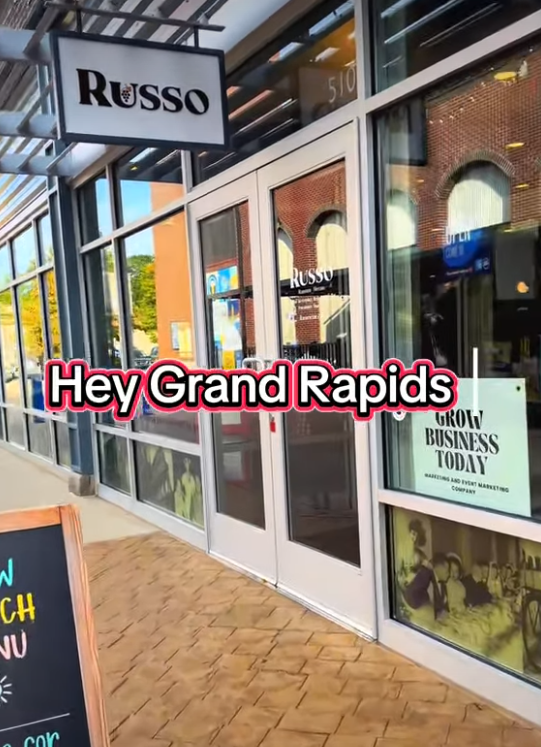 Russo restaurant storefront in Grand Rapids with glass doors and a sign;