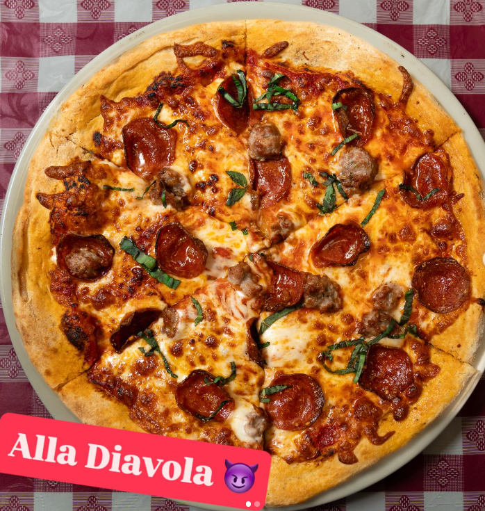 Pepperoni and sausage pizza on red checkered tablecloth, labeled