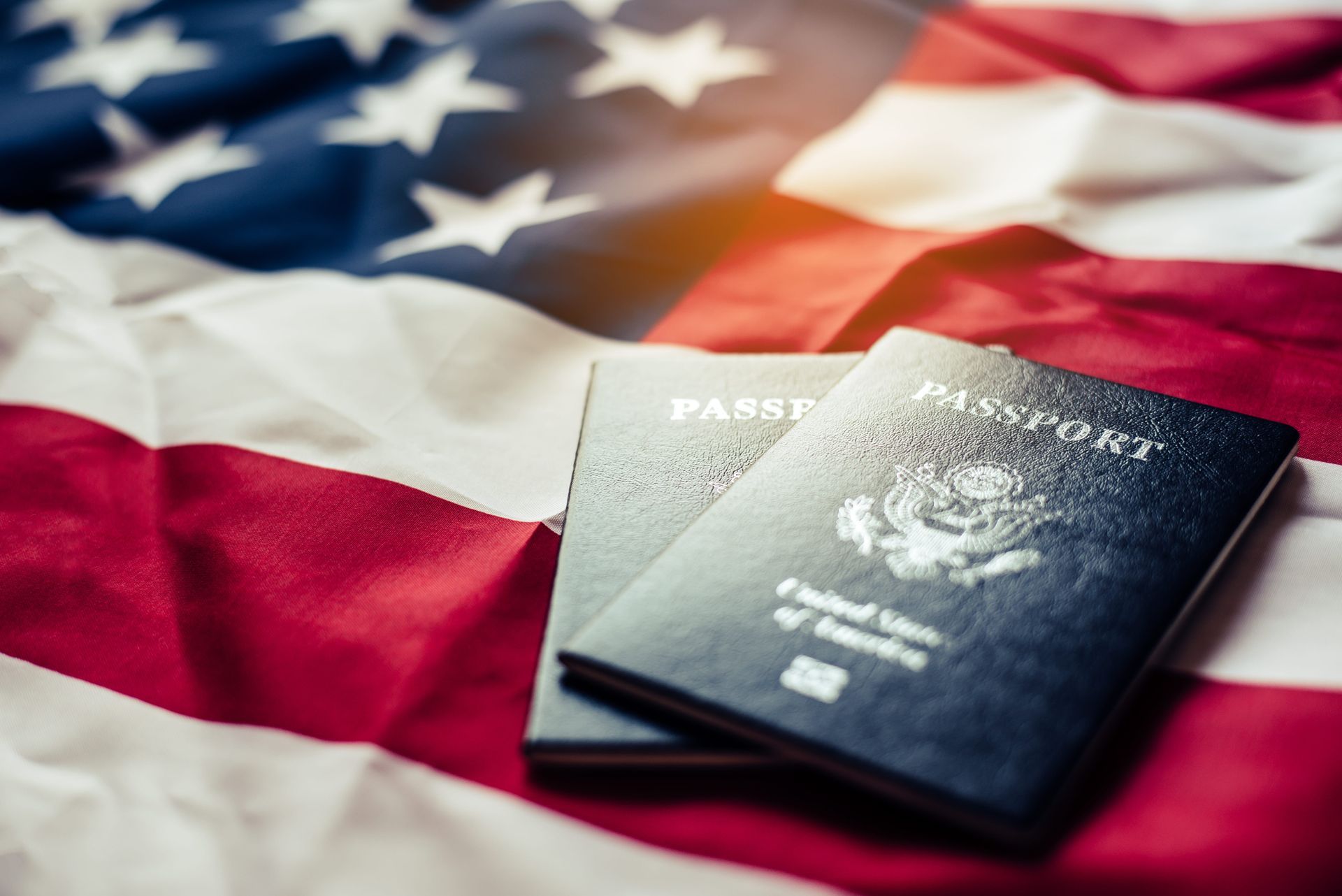U.S. passport on an American flag backdrop