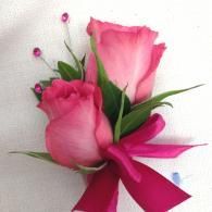 Pink rose bouquet with green leaves and a magenta ribbon
