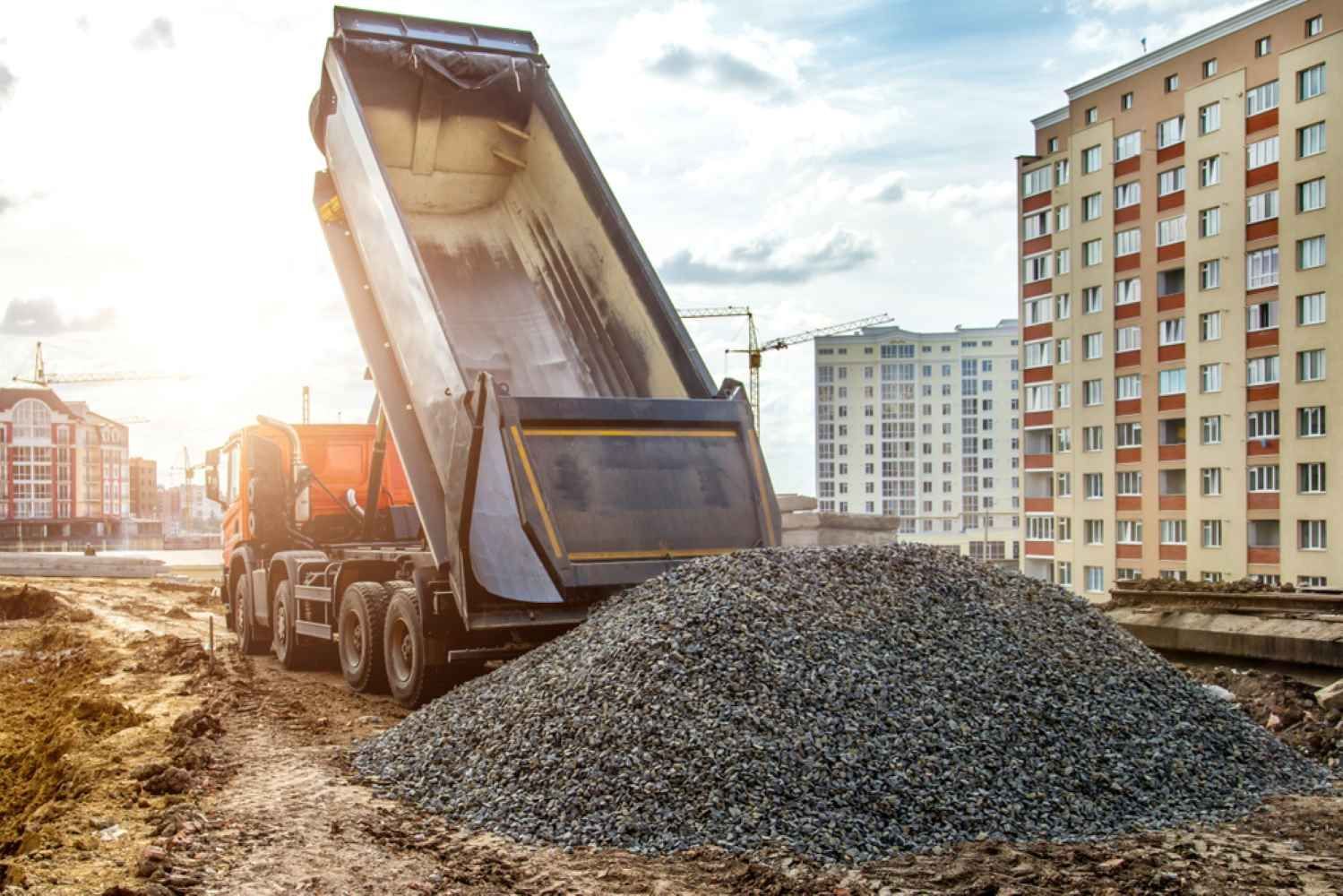 A Dump Truck is Dumping Gravel on a Construction Site — Burnett Contracting in Cloncurry, QLD