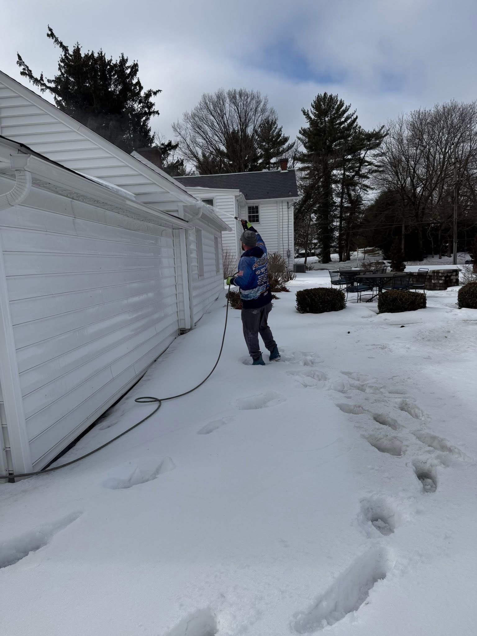 Pressure washer spraying water across a concrete surface