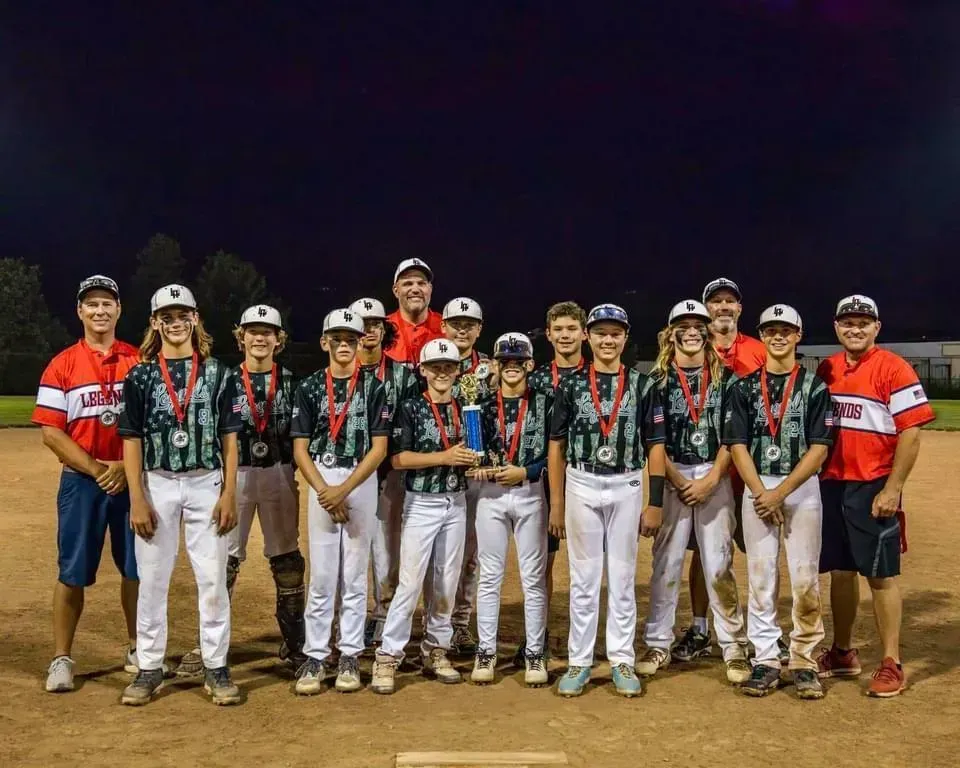 Legends Athletics baseball team holding a trophy