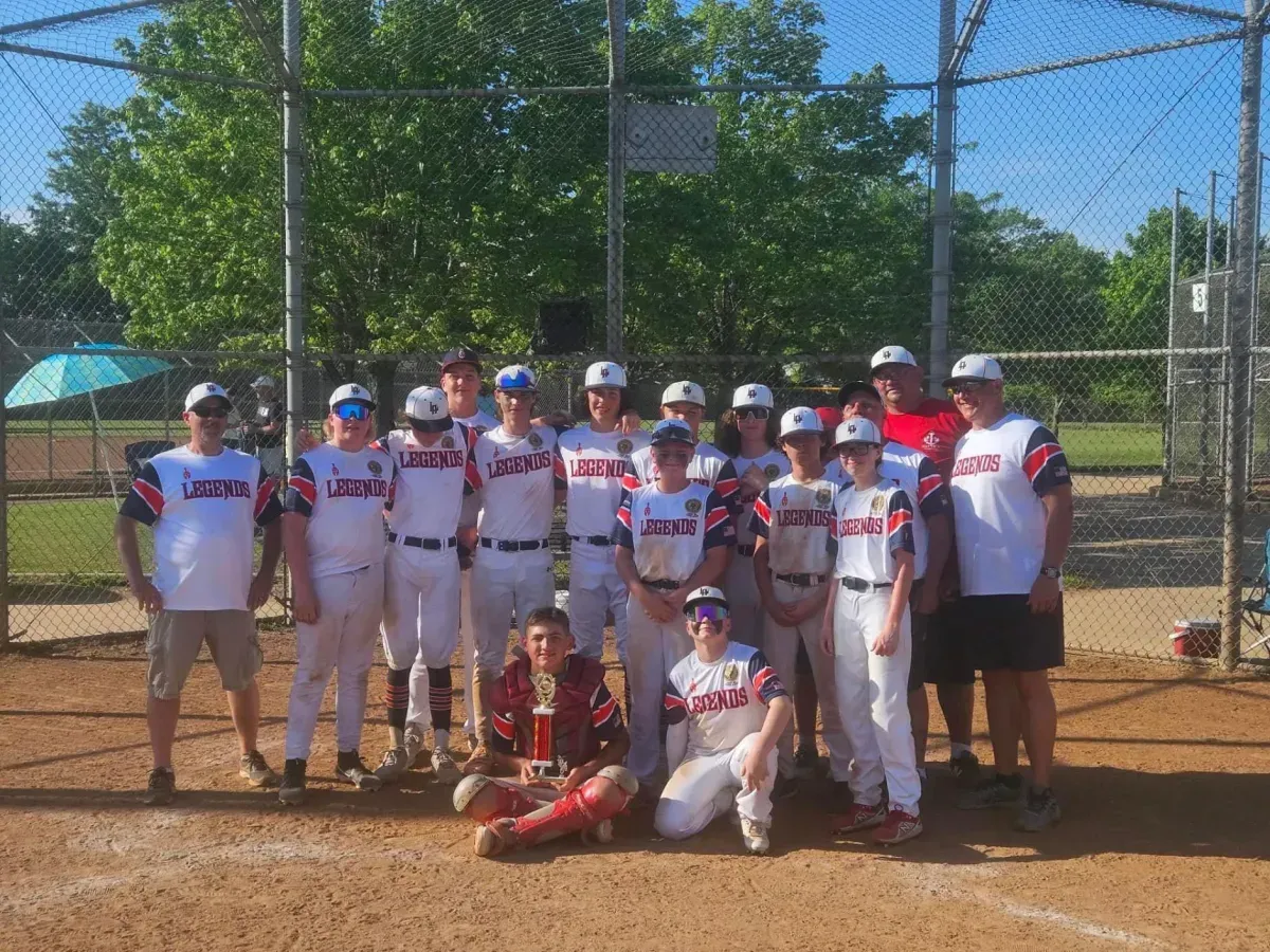 Legends Athletics baseball team holding a trophy