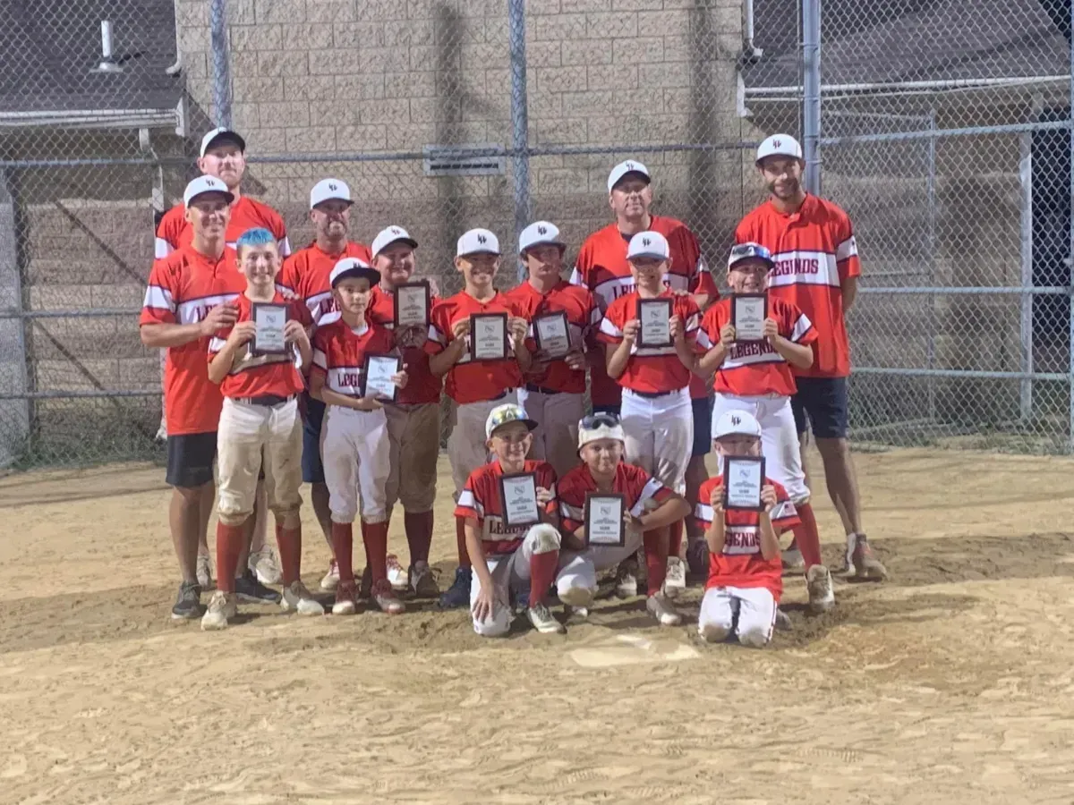 Legends Athletics baseball team holding plaques 