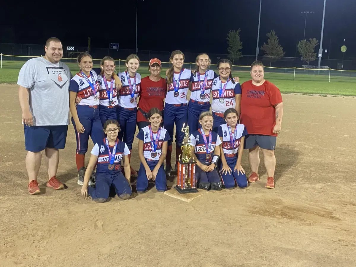 Legends Athletics softball team with a trophy