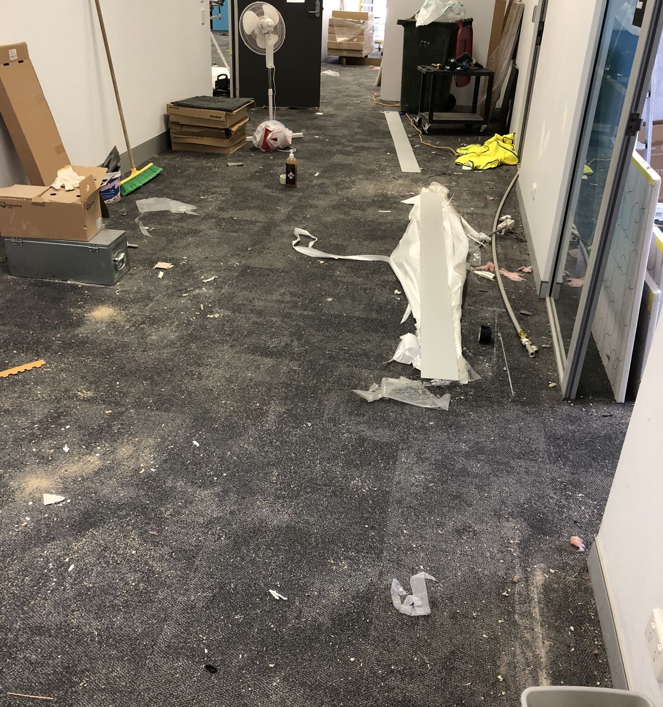Office corridor full of construction debris before a builders clean