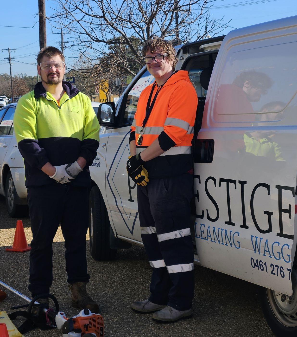 Jacob and John in hi-vis beside a Prestige van