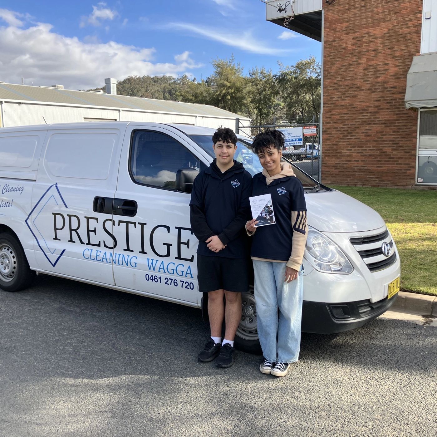 Giri and Naima beside a Prestige Cleaning Wagga van
