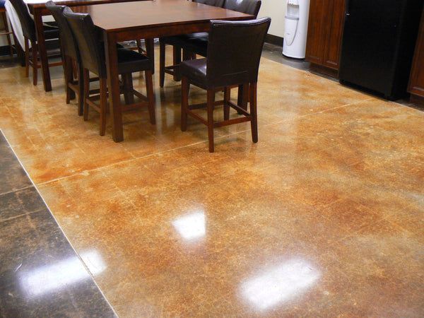 Empty kitchen with glossy brown tile floor and a dark wood dining table and chairs.