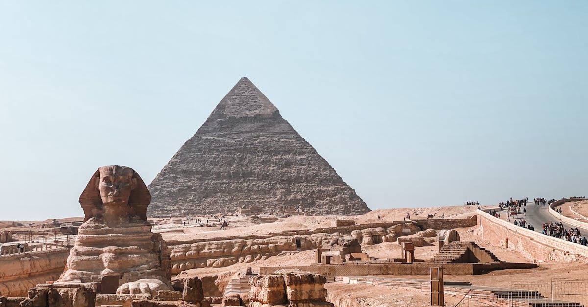 There is a pyramid and a sphinx in the background.