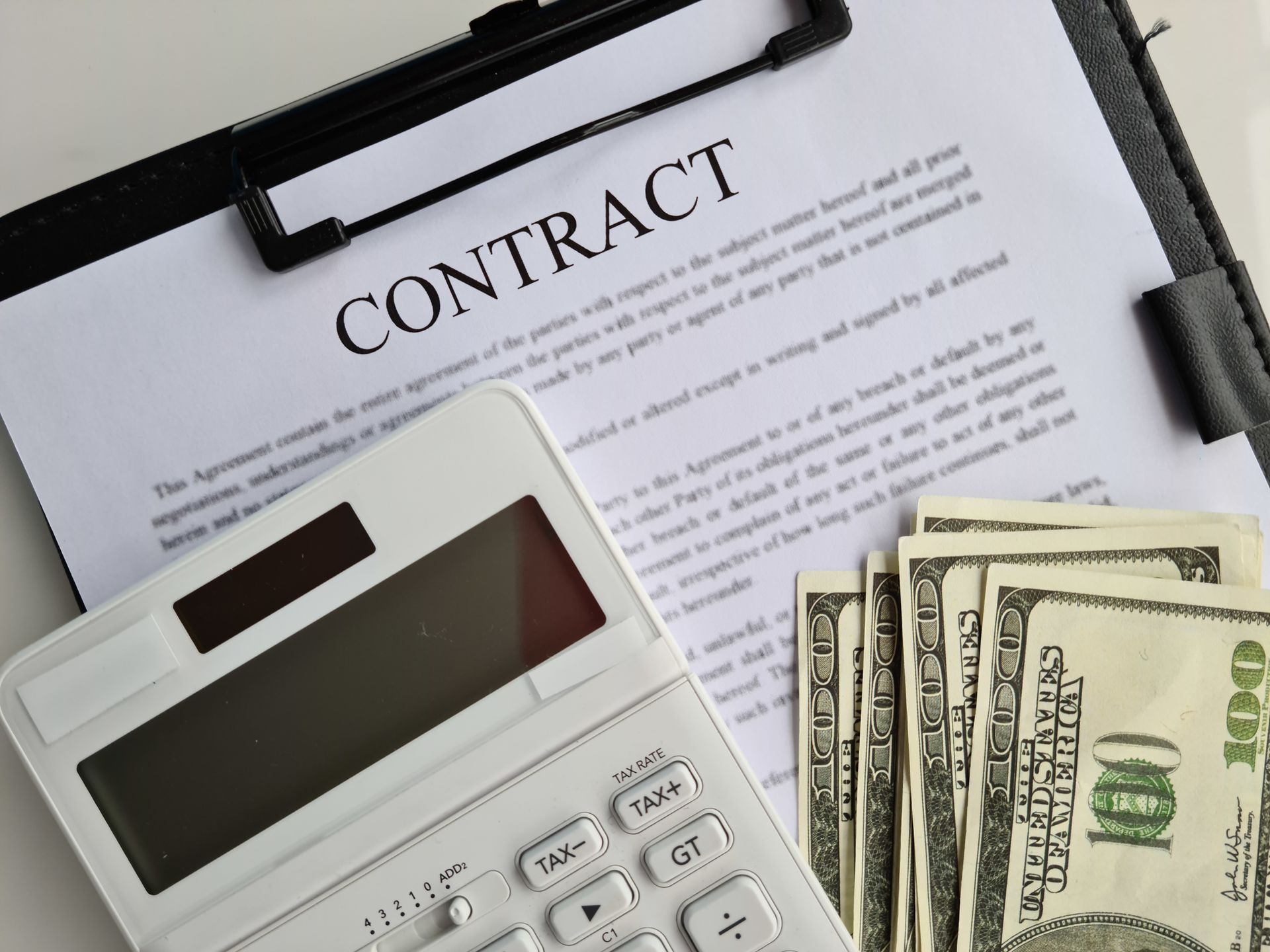 A clipboard with the word contract on it
