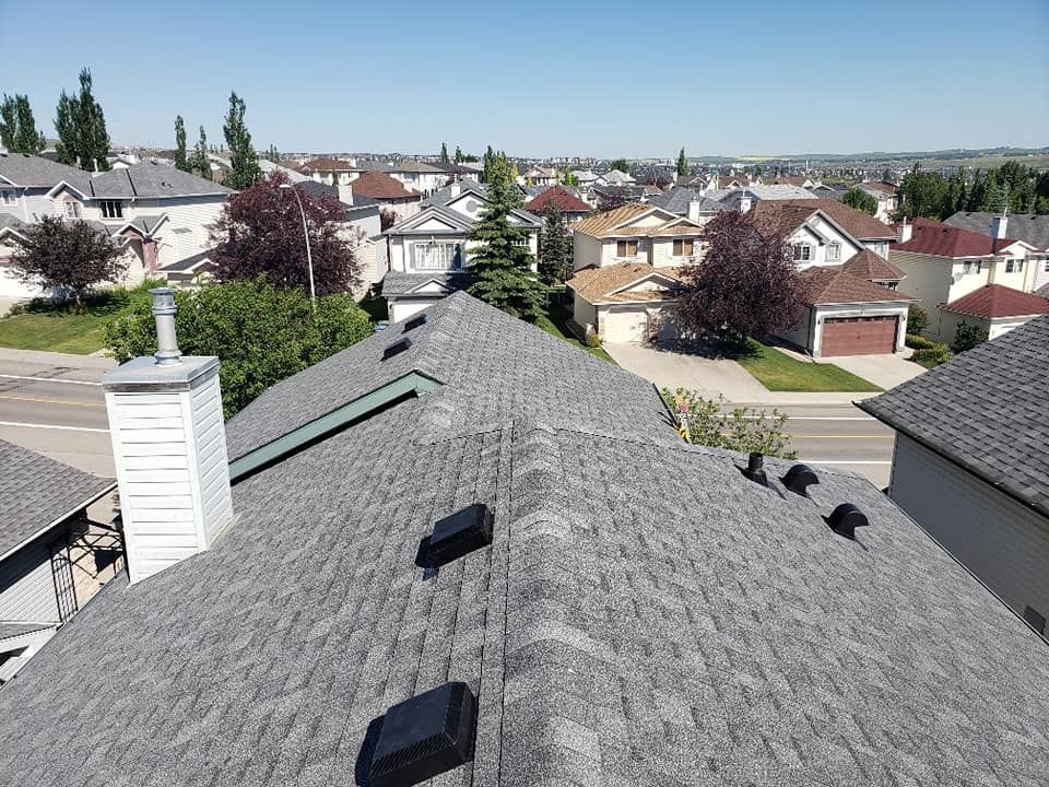 An aerial view of a roof of a house in a residential area.