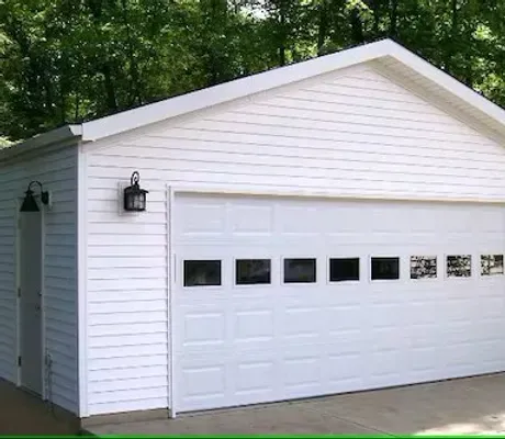 A white garage with a large white garage door