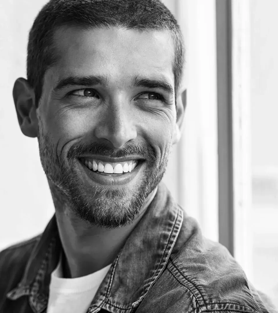 Man smiling confidently with a healthy white smile after cosmetic dentistry near Southampton