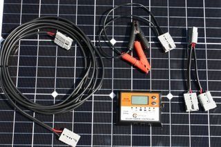 A Solar Panel With A Charger And Cables On It — Rainbow Beach Auto Electrics In Rainbow Beach, QLD