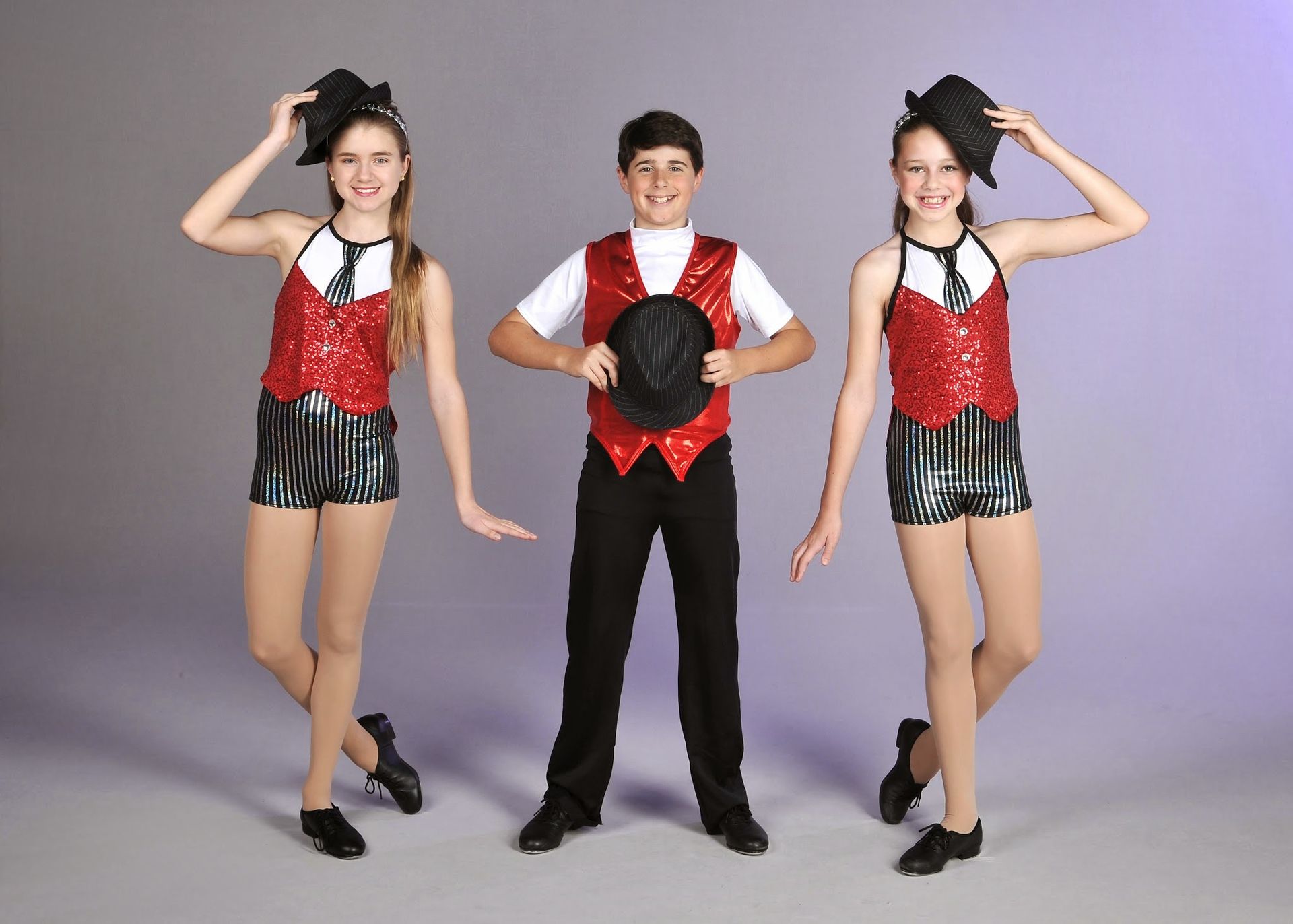 a boy and two girls are standing next to each other