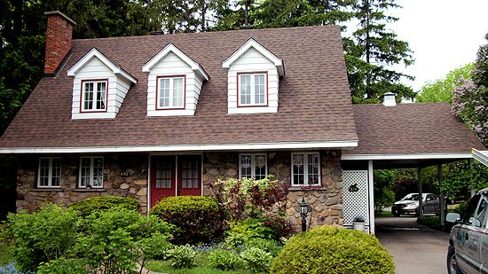 A house with a car parked in front of it