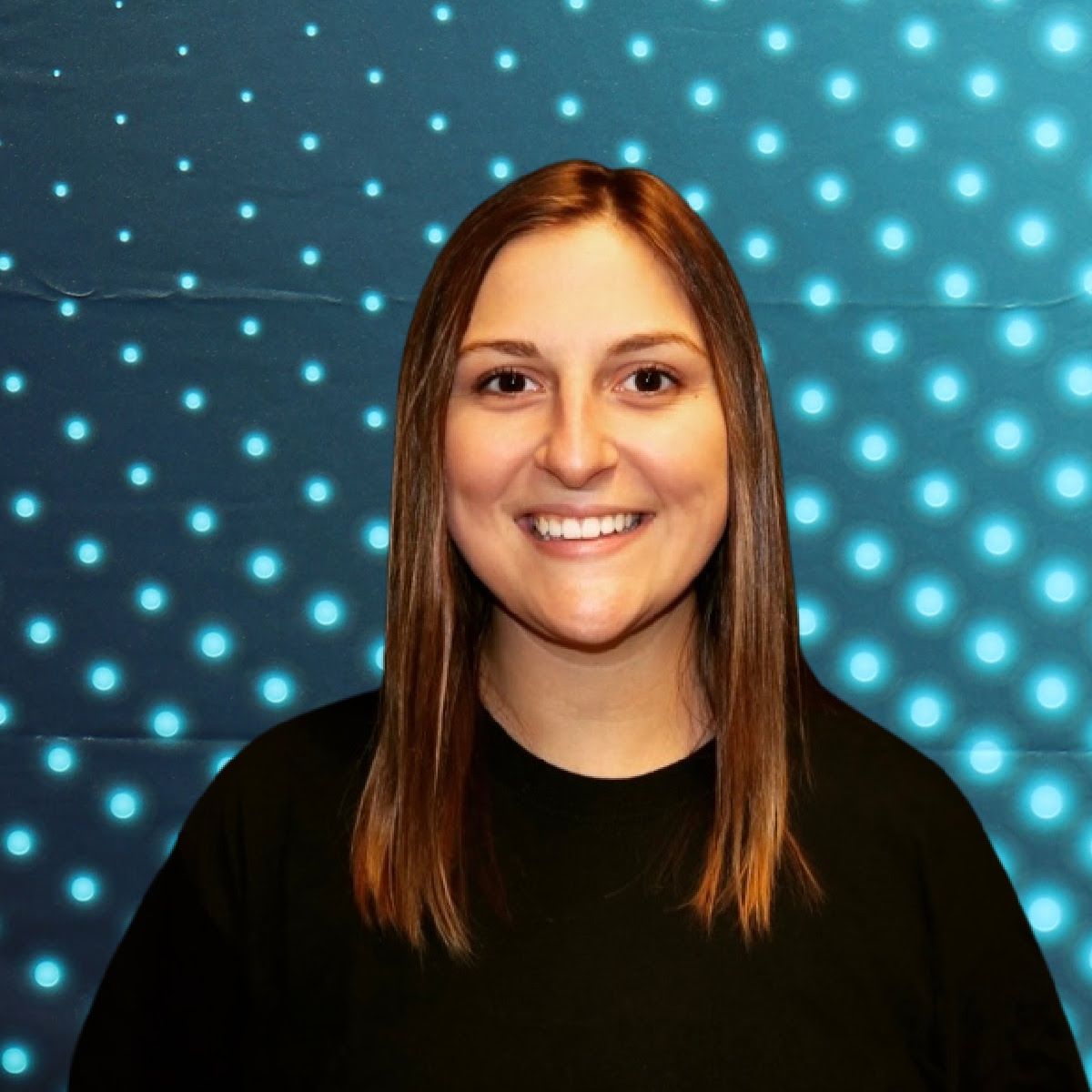Smiling woman in a black top against a blue dotted light background