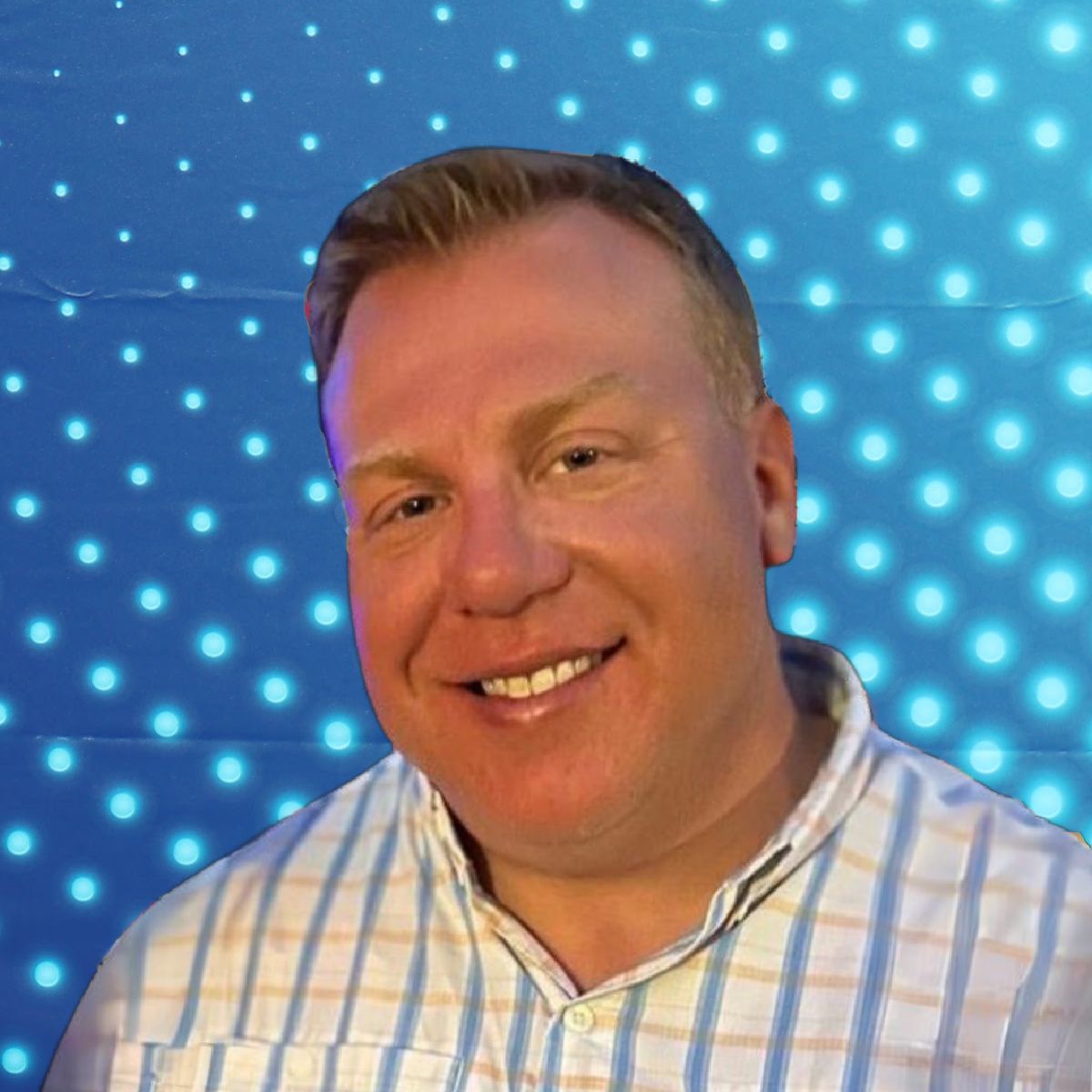 Smiling person in a striped shirt against a blue dotted light background