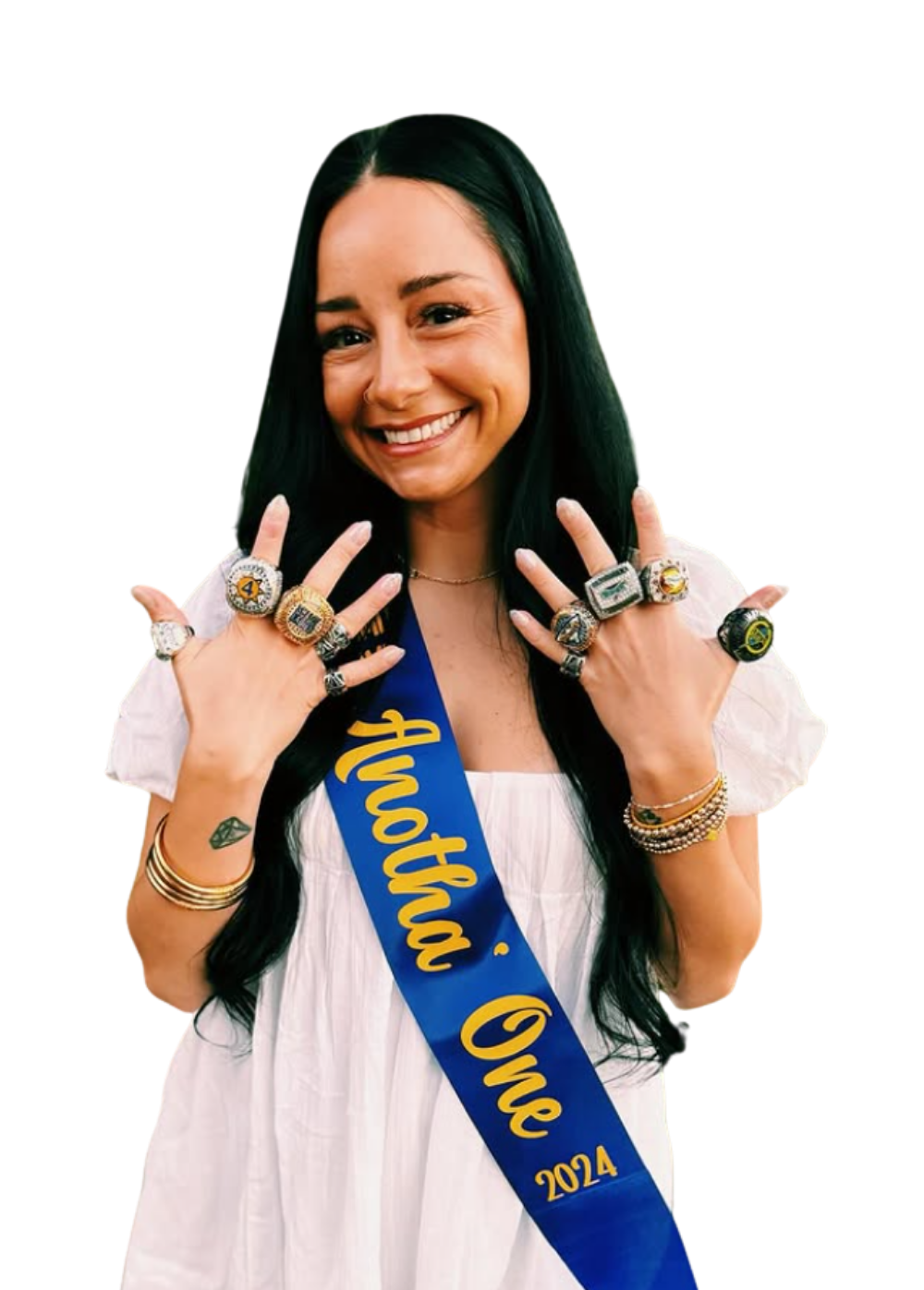 Smiling woman in white dress wearing blue sash and multiple rings, posing with hands raised