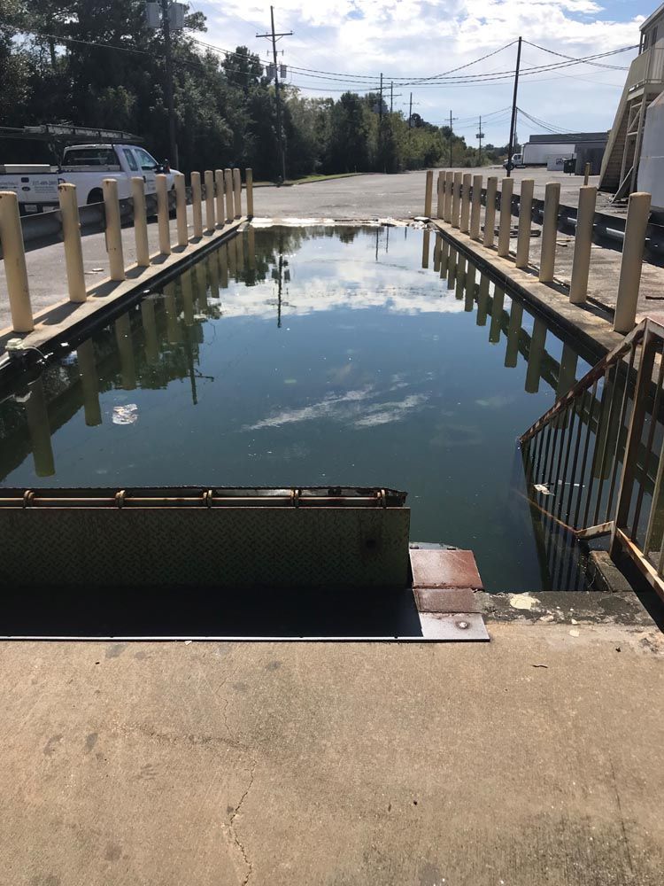 A large body of water is surrounded by a fence