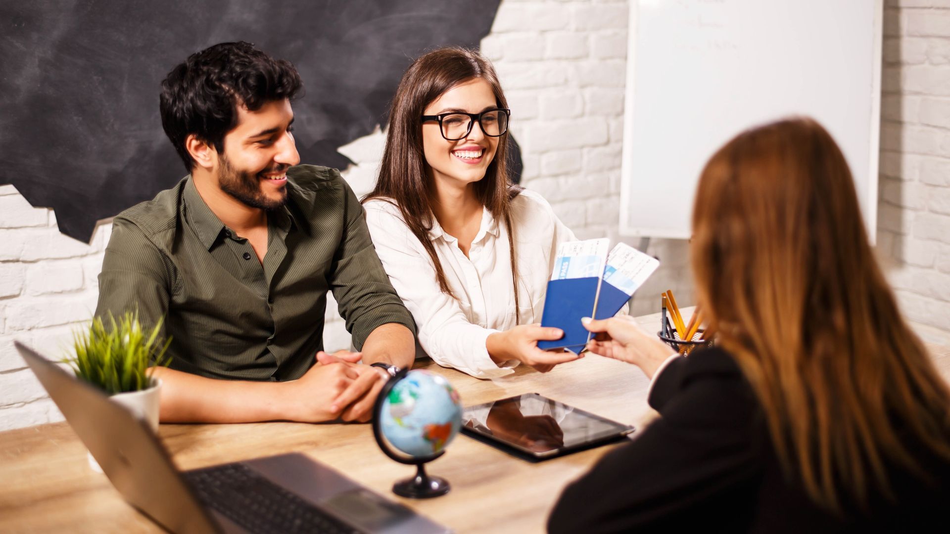 Couple choosing vacation with agent showcasing services at a travel agency. Couple choosing vacation with agent showcasing services at a travel agency.