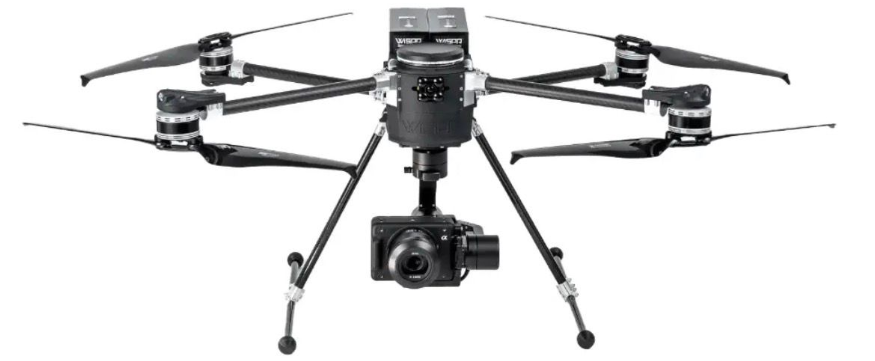 Hexacopter drone with mounted camera on landing gear, isolated on white background