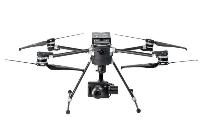 Black quadcopter drone with camera and landing gear on a white background