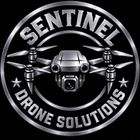 Silver circular logo reading &ldquo;SENTINEL DRONE SOLUTIONS&rdquo; with a drone centered on a black background