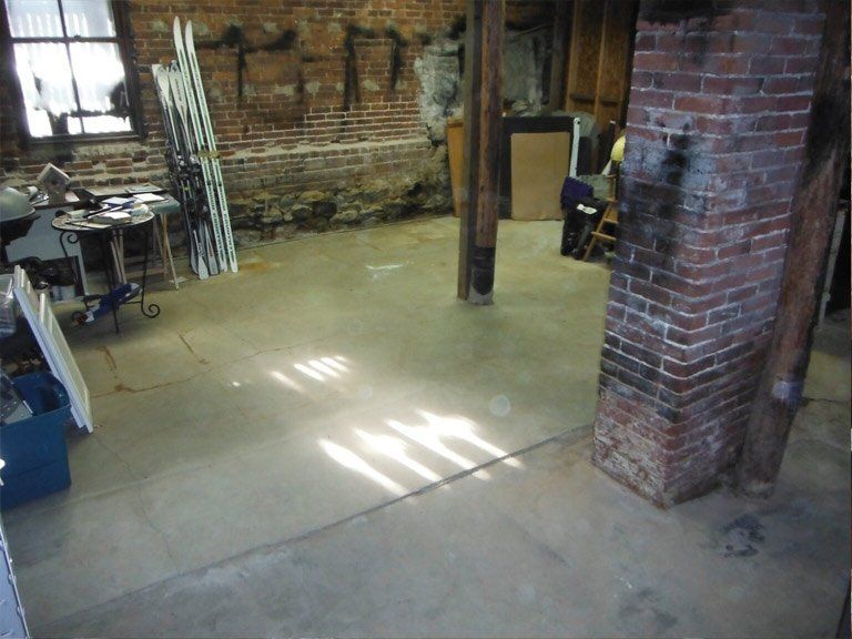 A room with a brick wall and a brick chimney