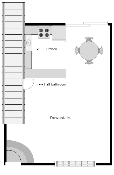 Floor plan of a small downstairs area: kitchen, half bathroom, dining table, and stairs leading up.