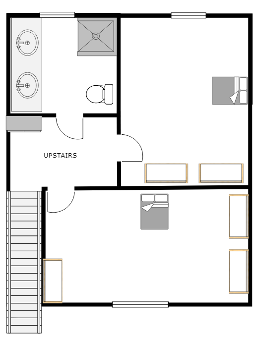 Floor plan of a two-story home. Upstairs shows bathroom fixtures and a bedroom; downstairs, a bedroom and stairs.