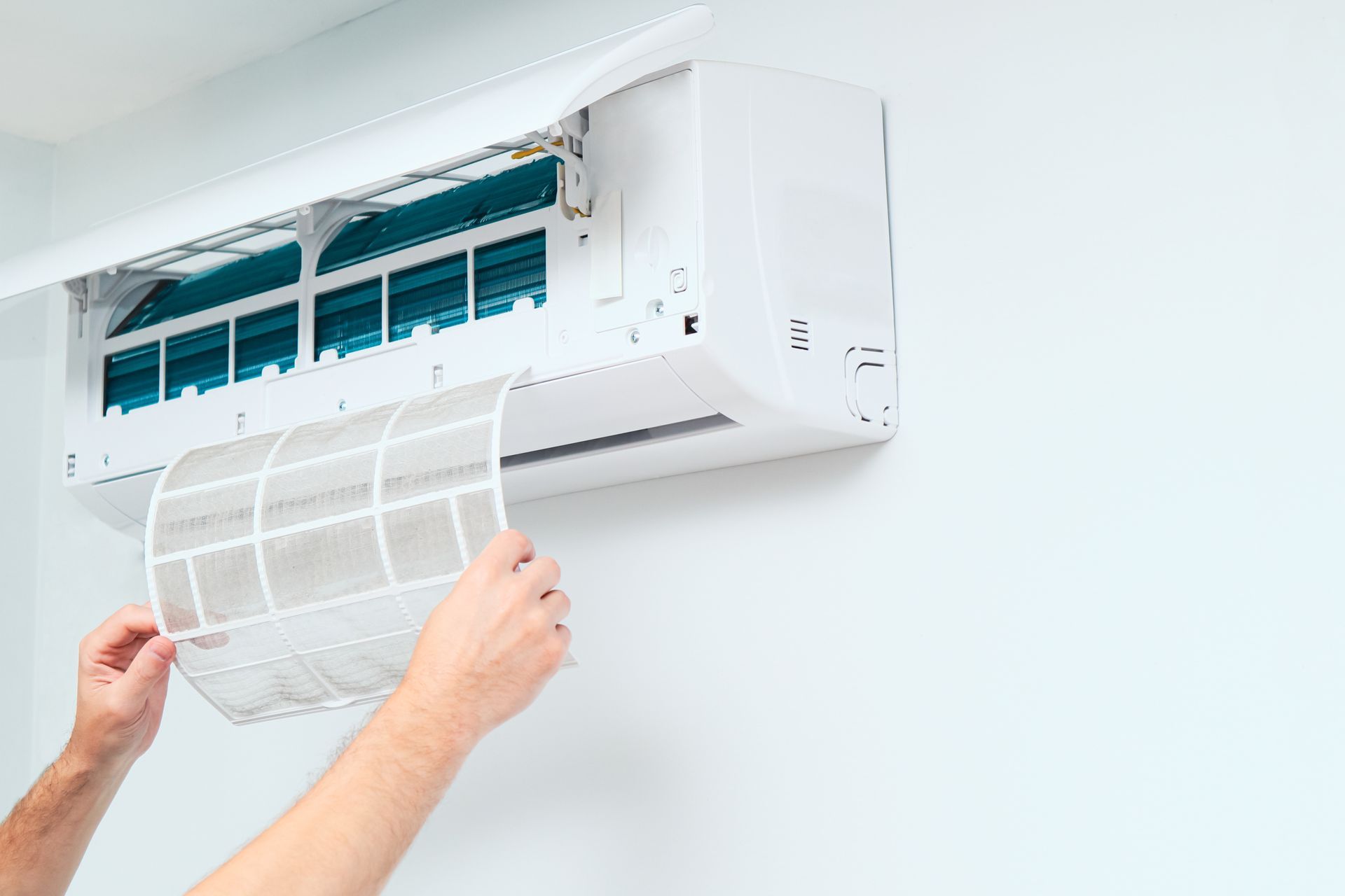 Air conditioning maintenance contractor replacing a home AC filter. Air conditioning maintenance contractor replacing a home AC filter.