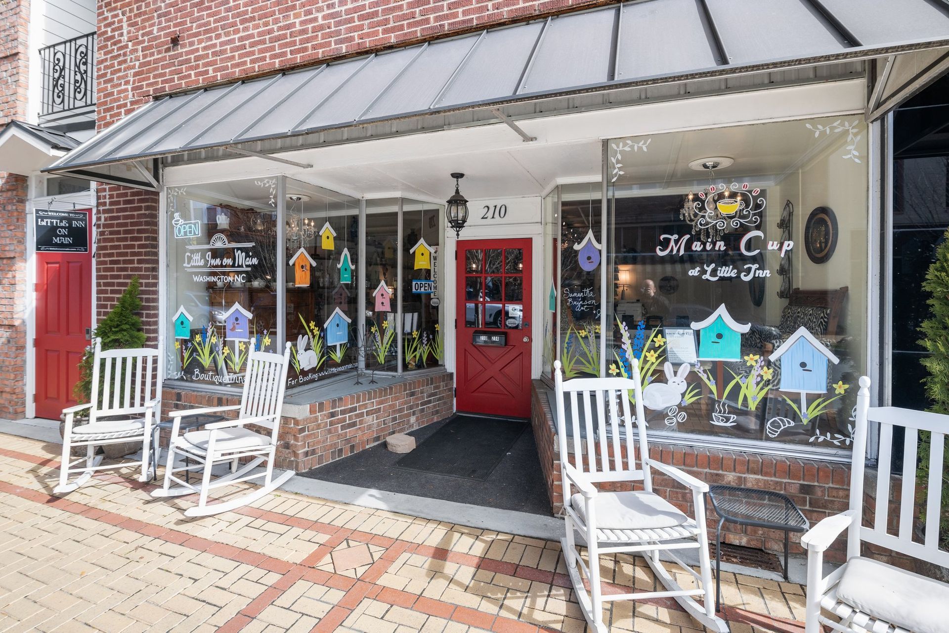 A store front with rocking chairs in front of it.