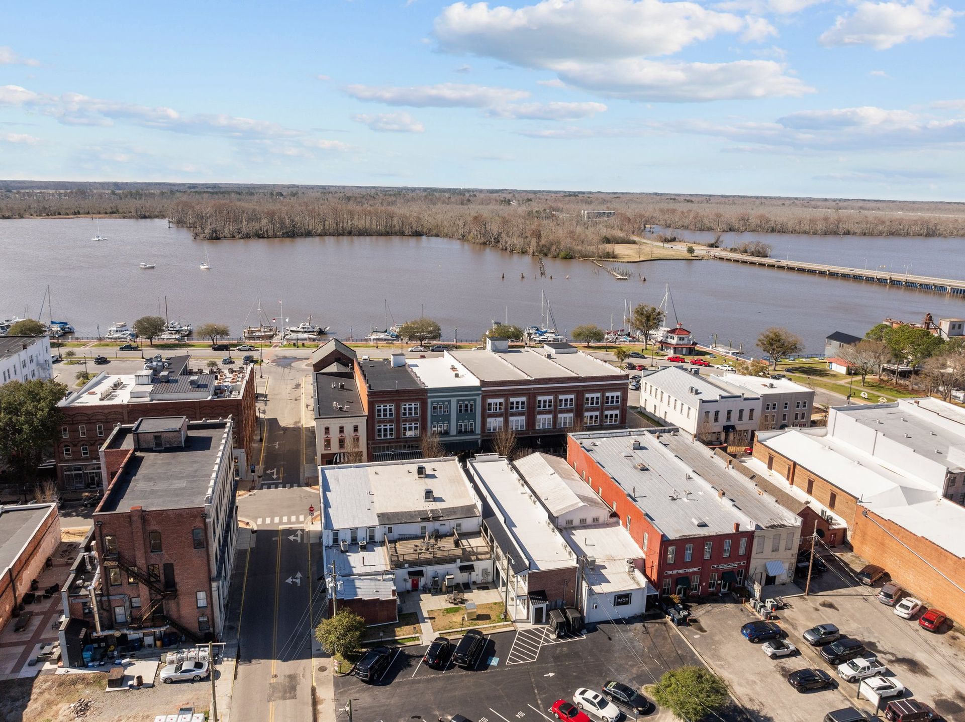An aerial view of a city with a river in the background.