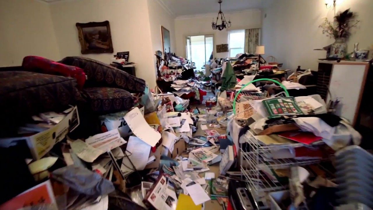 A living room with a lot of papers on the floor