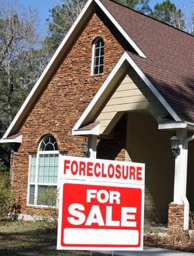 A house with a foreclosure sign in front of it