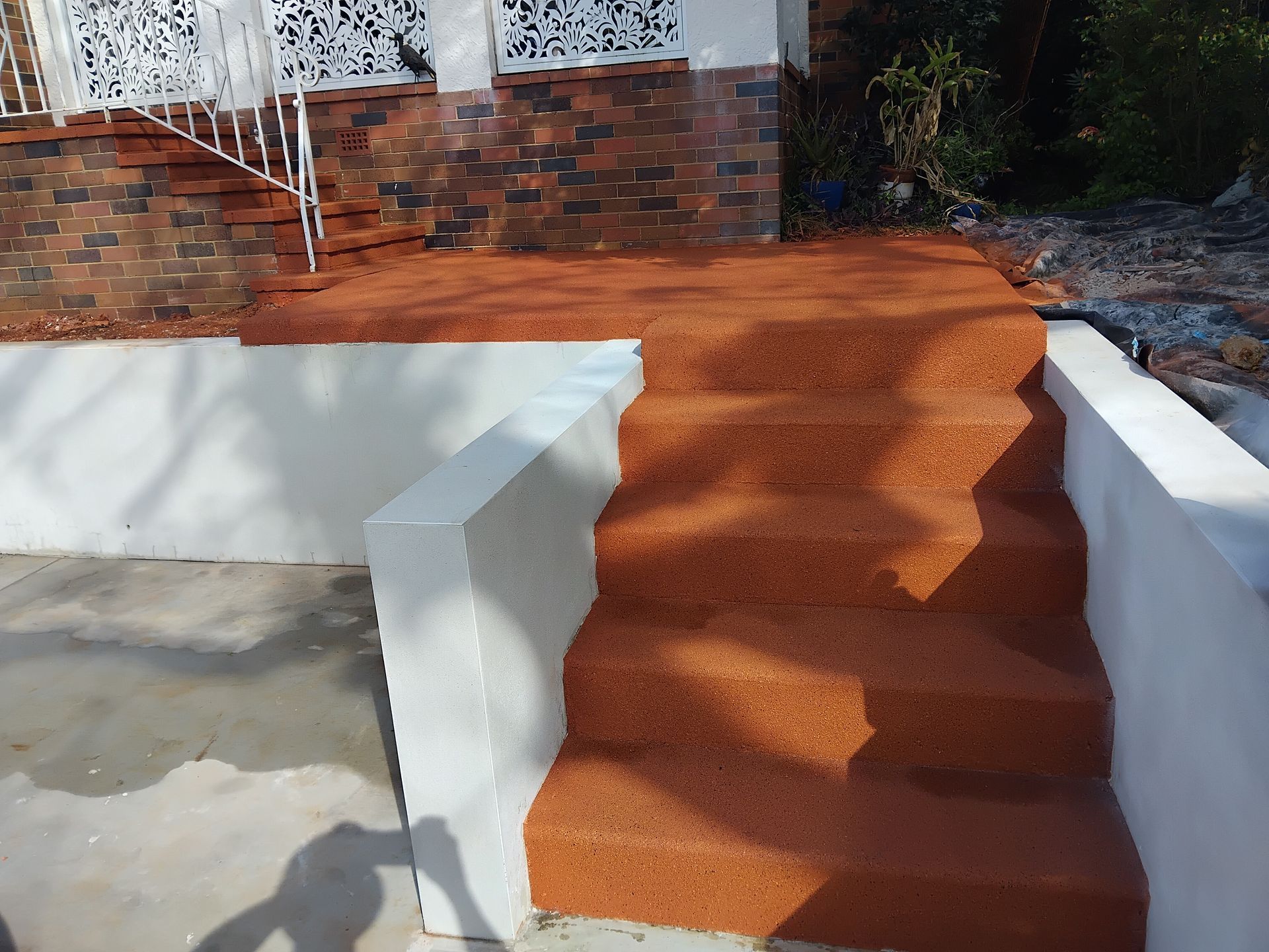 Orange resurfaced concrete - — Troys Concrete Overlays in Hillcrest, QLD